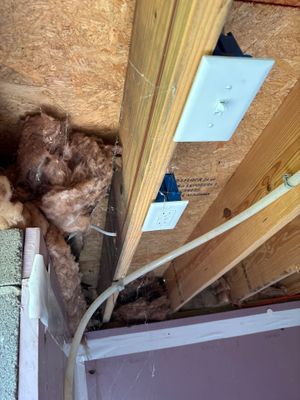 Crawlspace encapsulation installation in progress showing exposed foundation framing, vapor barrier material being