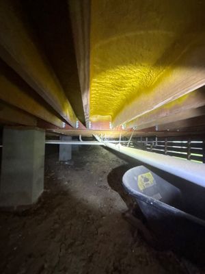 An underground crawlspace or basement area with interior drainage channel installed along the foundation perimeter,