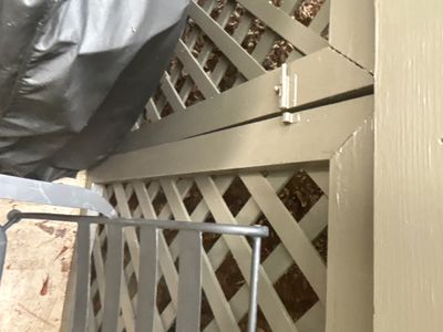 Installation of a crawlspace encapsulation system with vapor barrier material being applied to foundation walls and