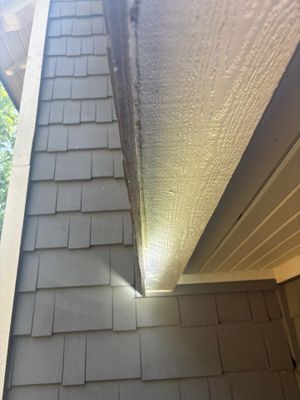 Interior basement foundation wall with installed drainage system and lighting, showing completed waterproofing work