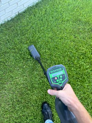 A Sentricon moisture detection device is being used to assess soil conditions and moisture levels in a lawn area,