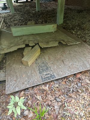 Concrete lifting and void-fill preparation under a foundation, with exposed subsurface showing a wooden block spacer