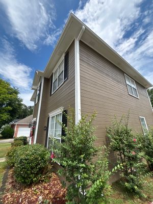 Exterior view of a two-story residential home with landscaping and no visible foundation repair work or waterproofing