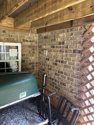 Interior foundation basement with a sump pump basin installed and interior drainage channel visible along the brick