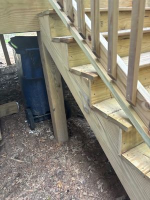 Exterior foundation area showing a blue drainage pipe or downspout extension and wooden framing for what appears to be