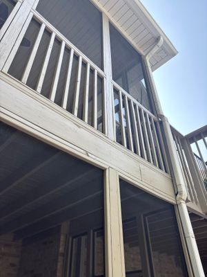 Exterior view of a two-story residential home with a deck and screened porch showing no visible foundation repair work