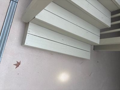 Installed white I-beams or support beams mounted horizontally to the ceiling/foundation structure as completed