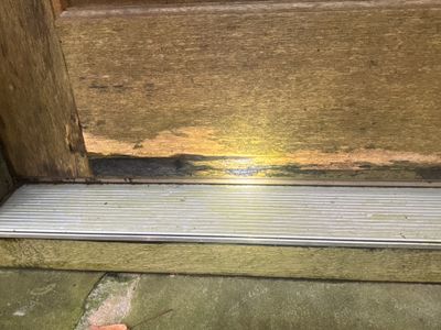 Interior drainage channel or perimeter drain system installed along the foundation basement floor with visible white
