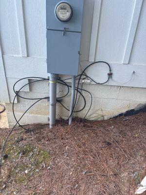 An exterior yard drainage system with a catch basin and discharge lines installed at the foundation perimeter,