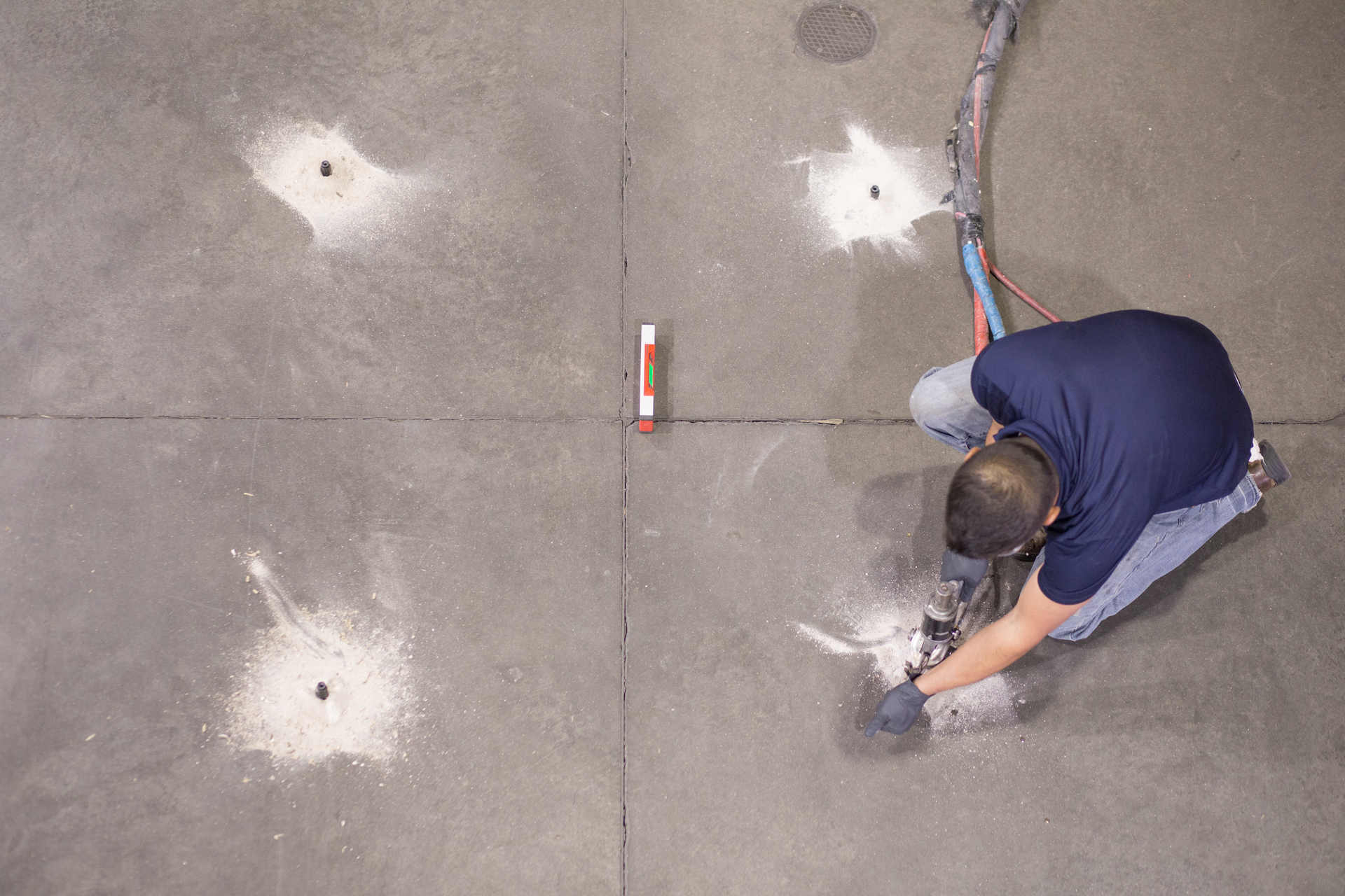 APS Foundation Repair and Waterproofing technician drilling holes for polyurethane foam injection.