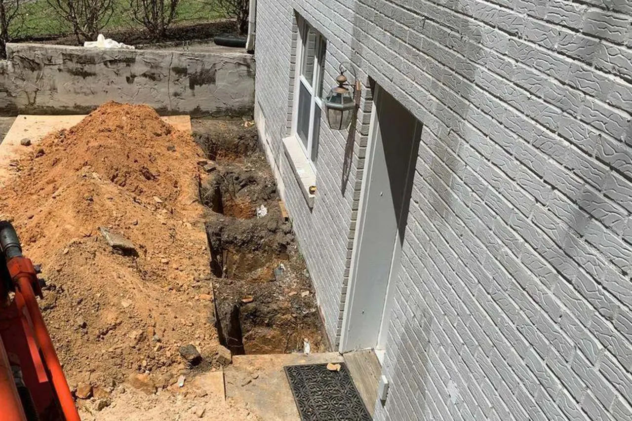 APS Foundation Repair and Waterproofing performing foundation excavation for helical pier installation.