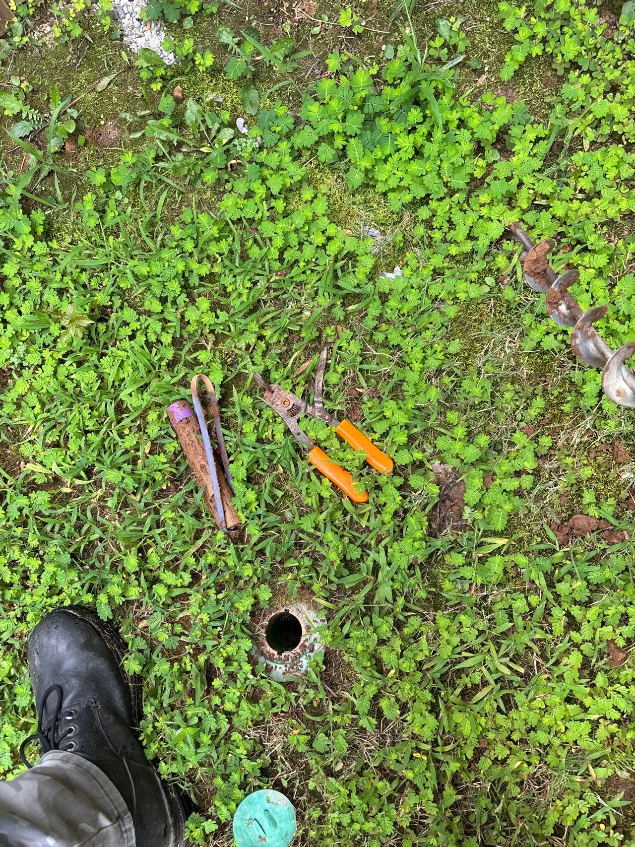 APS Foundation Repair and Waterproofing inspecting or installing a crawl space access well with tools on the ground