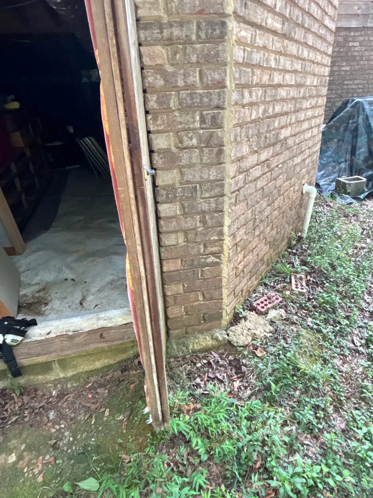 APS Foundation Repair and Waterproofing inspecting deteriorating concrete and crawl space access in Columbiana, AL.