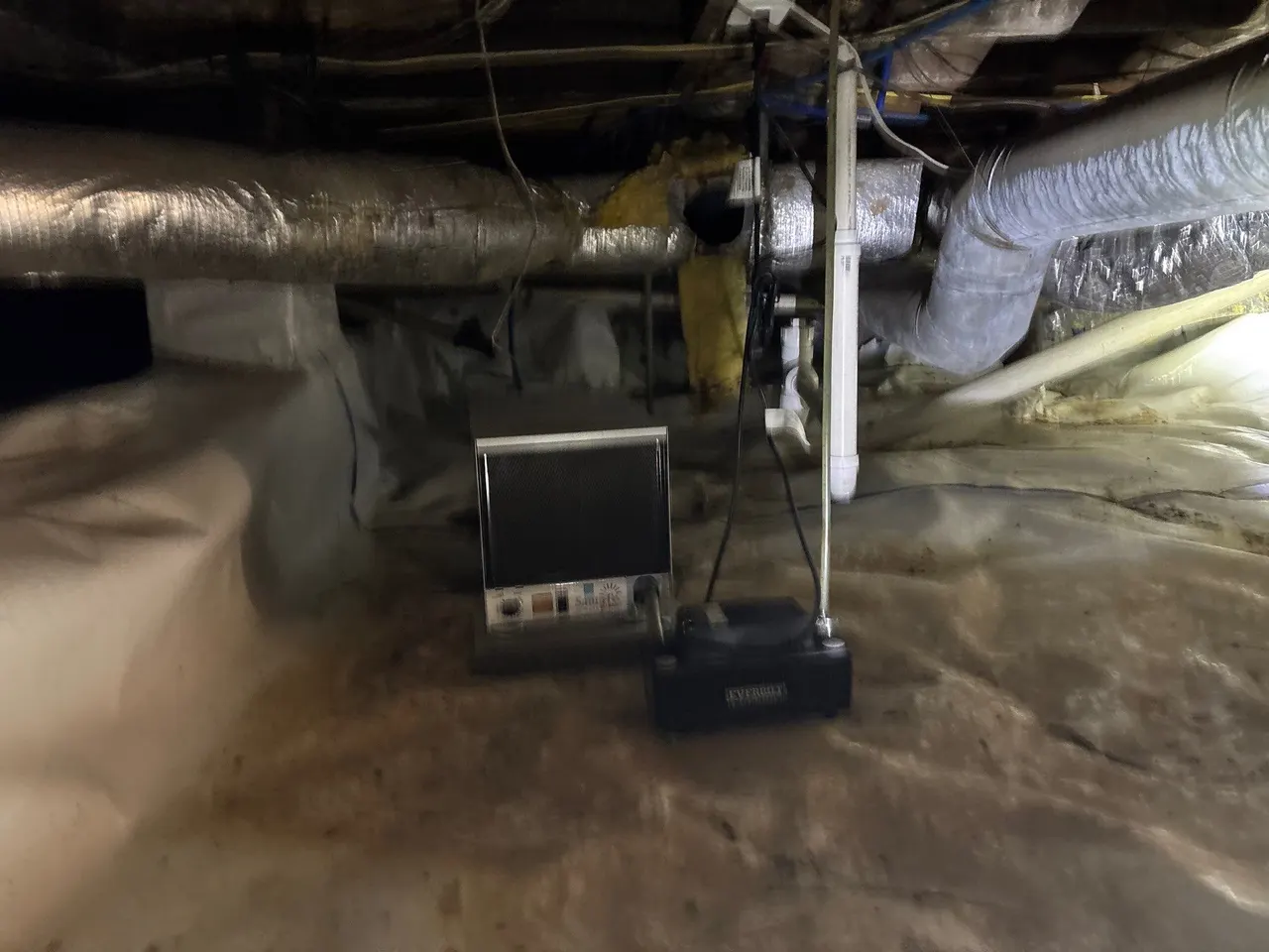 APS Foundation Repair and Waterproofing installing a crawl space dehumidifier and pump system for moisture control