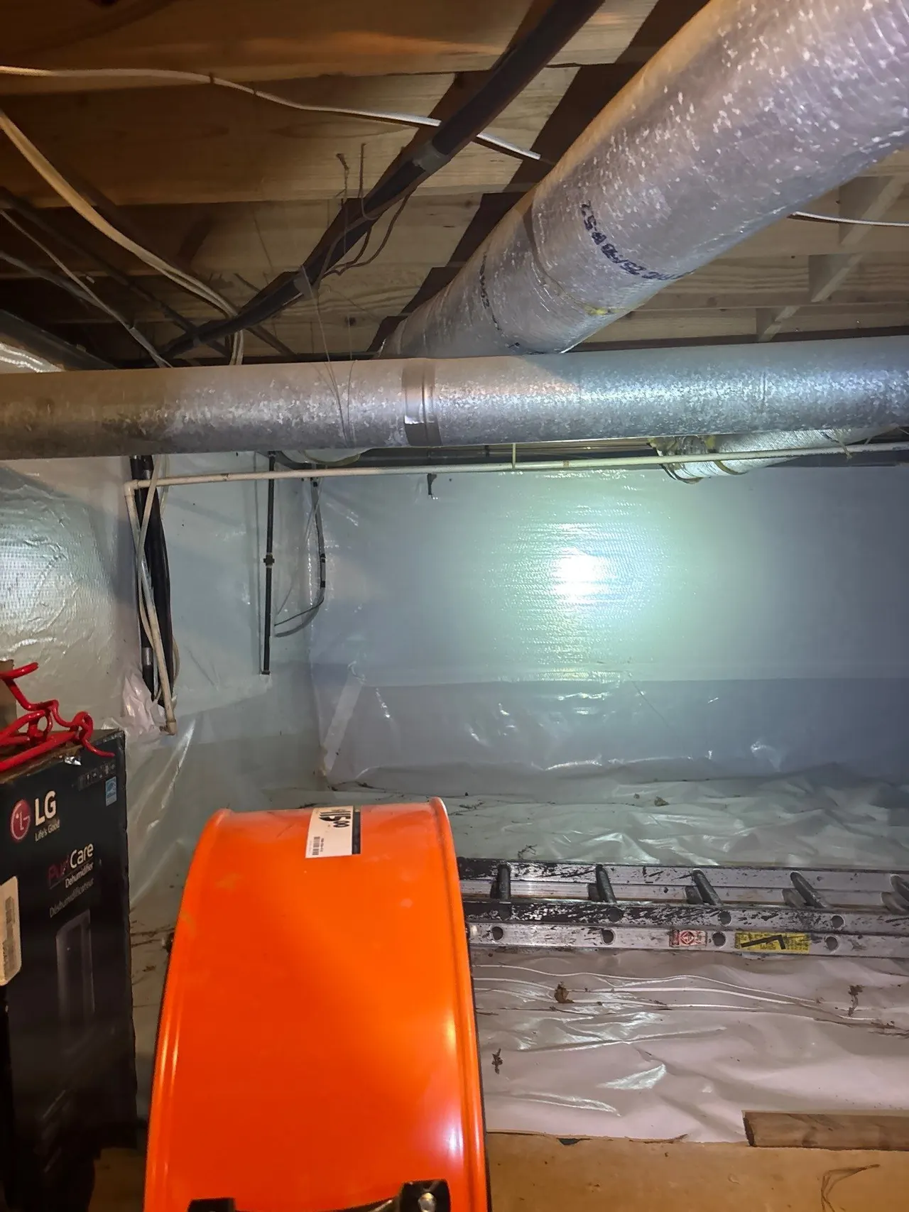 APS Foundation Repair and Waterproofing installing a crawl space vapor barrier and dehumidifier for moisture control