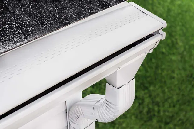 APS Foundation Repair and Waterproofing showcasing a durable gutter guard system and downspout.