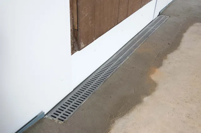 APS Foundation Repair and Waterproofing installing a channel drain for crawl space drainage and moisture control.