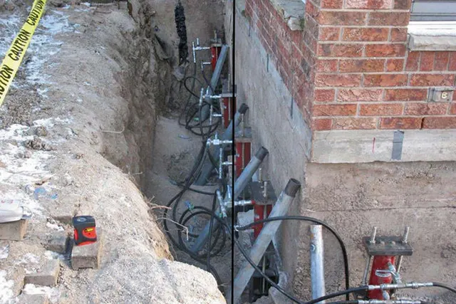 APS Foundation Repair and Waterproofing installing hydraulic push piers for residential foundation leveling.