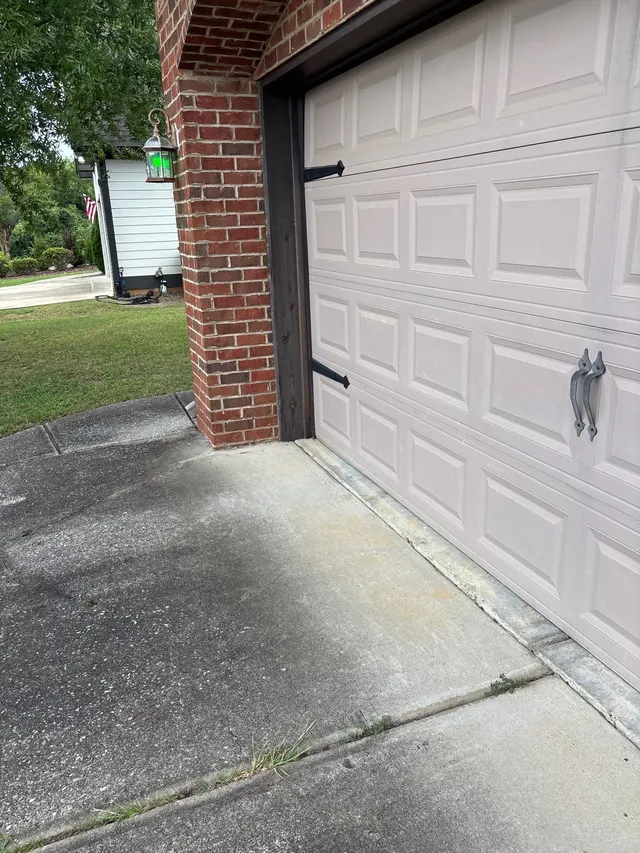 APS Foundation Repair and Waterproofing inspecting a cracked and deteriorated concrete driveway with visible fissures